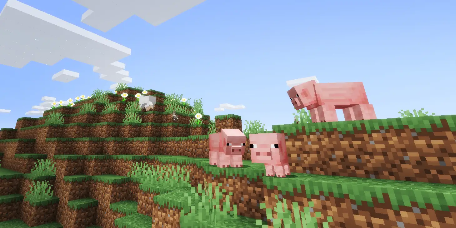 在遊戲Minecraft有三隻豬在山崖之上的圖像。